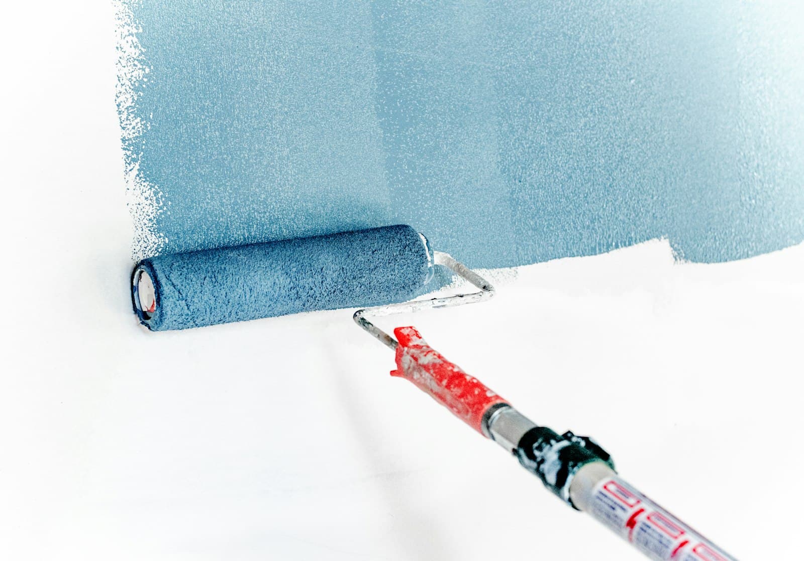 Painter rolling color onto an interior wall