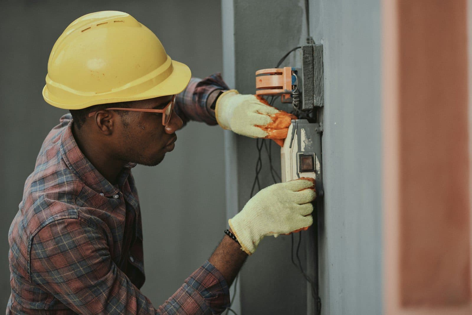 Electrician working at an open panel